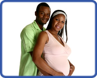 man with arms around pregnant woman